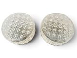 pair of silver plated ear plugs on a white background