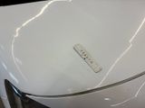 a sticker on the hood of a white car