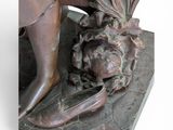 statue of a woman holding a pineapple on a marble base