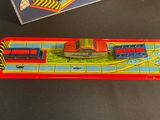 a toy train on the table next to a box