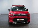 the front of a red citrole parked in a white room