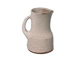 a white pitcher that is sitting on a table