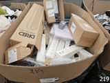 many boxes of electronic devices in a pile on the street