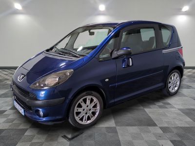 a picture of a small blue car on a checkered floor