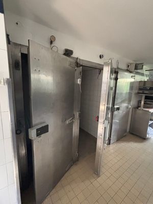 two stainless steel doors that are open in a kitchen