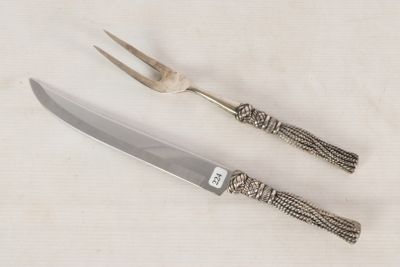 a knife and a fork sitting next to each other on a table