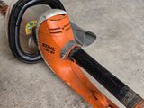 a chainsaw that is laying on the ground in the garage