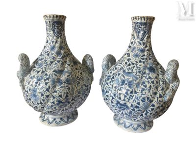 paire de vases bleus et blancs posés sur une surface blanche