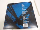 the back cover of a blue album with a black and white image of a tower