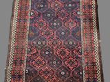 an antique persian rug with a blue and red design