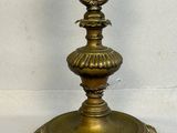 a gold candle that is sitting on a white table