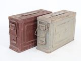 two old metal boxes sitting next to each other on a white surface