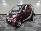 a small car that is sitting on a checkered floor