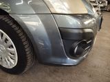 a close up of a car ' s front bumper and exhaust pipe