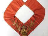 an image of a red and gold collar with a deer on it