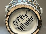 a close up of a cup with a writing on it