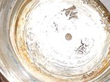 a close up of a silver plate with a clock on it