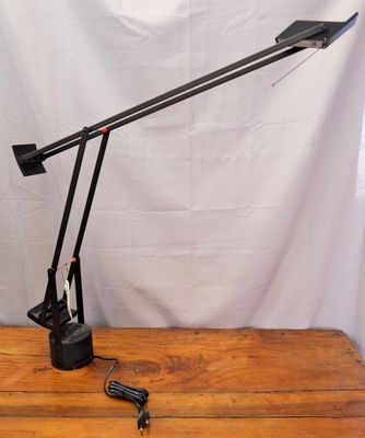 an image of a desk lamp that is on a wooden table