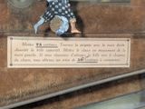 a figurine of a man sitting on top of a suitcase