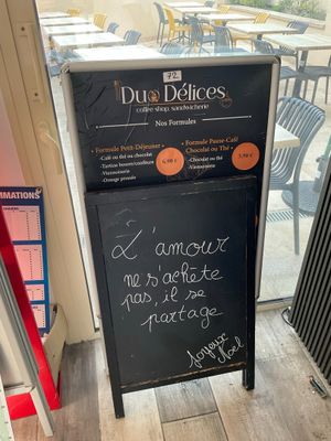 a sign outside of a restaurant with a menu written on it