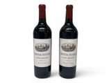 two bottles of wine sitting next to each other on a table