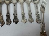 a lot of spoons and forks on the table