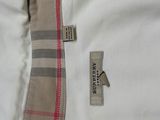 the jacket is white and has a checkered pattern on the collar