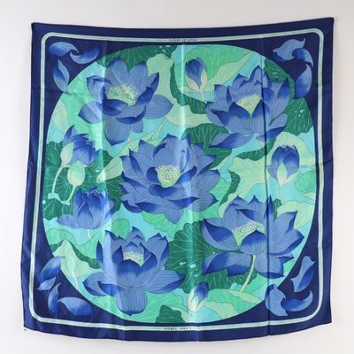 a blue and green floral print scarf hanging on a wall