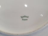 a white plate that has a green and white logo on it