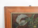 an oil painting of a plant with leaves and berries in a wooden frame