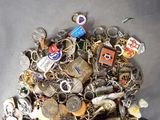 a pile of assorted key chains on a table