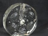 a glass object that is sitting on a black surface