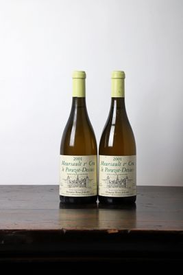 two bottles of wine sitting on top of a wooden table