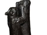 statue of a dog holding a cat in its paws