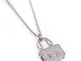 a close up of a necklace with a lock on it