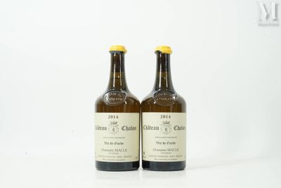 two bottles of wine sitting on top of a white table