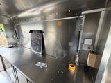 stainless steel counter top in a commercial kitchen with a chalkboard