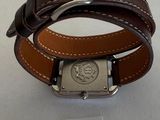 a watch with a brown leather band and a silver buckle