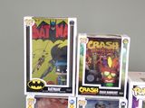batman action figures are stacked on top of each other on a table