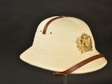 an old hat with a leather band is on a stand