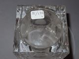 a clear glass candle holder with a sticker on it