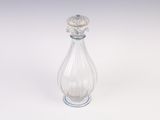 flacon de parfum en verre transparent orné d'une fleur sur le bouchon