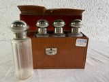 bottles of perfume sitting in front of a wooden box on a table