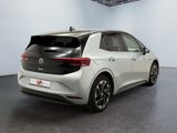 the rear of a white volkswagen e - golf parked in a room