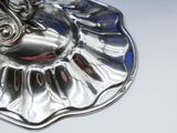 a silver plate with a horse on it on a table