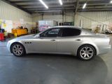 an image of a silver mas car parked in a garage