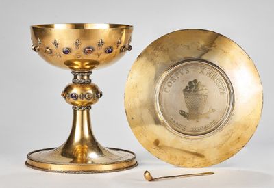 brass chalicet and plate on a stand with a small stick