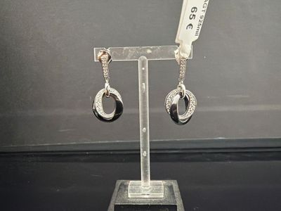 une paire de boucles d'oreilles exposées sur un présentoir