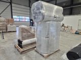 several rolls of plastic wrap are stacked on pallets in a warehouse