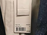 the back of a white shirt with a tag on it